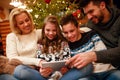 Smiling family having fun on digital tablet for Christmas Royalty Free Stock Photo