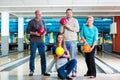 Smiling family holding bowling ball Royalty Free Stock Photo