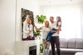 Smiling family holding photo canvas