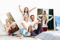 Smiling family holding photo canvas