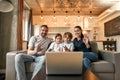 Smiling family with kids talk on video call on laptop