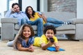 Smiling family in living room looking tv Royalty Free Stock Photo