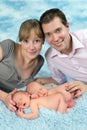 Smiling family with newborn twin babies