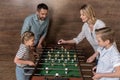 Smiling family playing foosball together Royalty Free Stock Photo