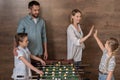 Smiling family playing foosball together Royalty Free Stock Photo