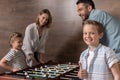 Smiling family playing foosball together Royalty Free Stock Photo