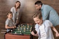 Smiling family playing foosball together Royalty Free Stock Photo