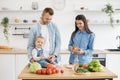 Smiling family preparing meal together in kitchen interior Royalty Free Stock Photo