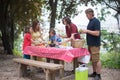 Smiling family setting table for picnic Royalty Free Stock Photo