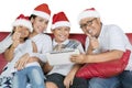 Smiling family with thumbs and tablet at Christmas Royalty Free Stock Photo