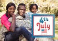 Smiling family siting on the grass for the 4th of july Royalty Free Stock Photo