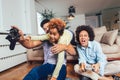 Family sitting on the couch together playing video games, selective focus Royalty Free Stock Photo