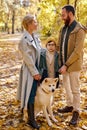 Smiling family spend autumn weekends outdoors, walking together in forest Royalty Free Stock Photo