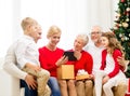 Smiling family with tablet pc and gift box at home Royalty Free Stock Photo