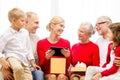 Smiling family with tablet pc and gift box at home Royalty Free Stock Photo