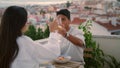 Smiling family testing champagne at balcony. Pair toasting glasses having dinner Royalty Free Stock Photo