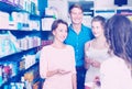 Smiling family of three consulting druggist Royalty Free Stock Photo