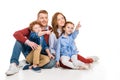 smiling family with two kids pointing away with fingers