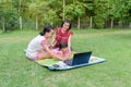 Smiling family using laptop outdoor Royalty Free Stock Photo