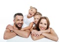 Smiling family in white t-shirts hugging