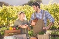 Smiling farmer couple holding chicken and eggs Royalty Free Stock Photo