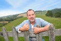 Smiling farmer by the fence