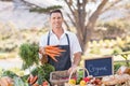 Smiling farmer holding a bunch of carrots Royalty Free Stock Photo