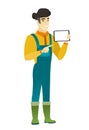 Smiling farmer holding tablet computer.