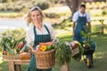 Smiling farmer woman holding a vegetable basket Royalty Free Stock Photo