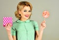 Smiling fashion girl with colorful lollipop and gift box. Woman with lollipop and present. Food sweet and sugar concept Royalty Free Stock Photo