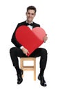 Smiling fashion model holding big red heart Royalty Free Stock Photo