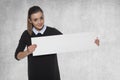 Smiling fashion woman holding a blank billboard, space for a lin