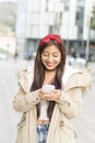 Smiling fashion woman using smart phone.