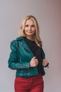 smiling fashionable mature woman in leather jacket
