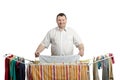 Smiling fat man in shirt drying laundry