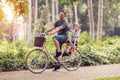 Smiling father with boy on bicycles having fun in park. Family s Royalty Free Stock Photo