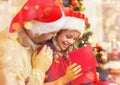 Smiling father and daughter opening gift box