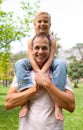 Smiling father giving his daughter piggy-back ride Royalty Free Stock Photo