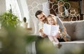 Smiling father and little cute daughter at home. Family time, togehterness, parenting and happy childhood concept