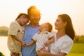 Smiling father and mother spending travel time with children at park Royalty Free Stock Photo