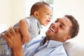 Smiling Father Playing With Baby Son At Home Royalty Free Stock Photo