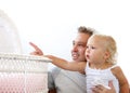 Smiling father showing baby daughter crib