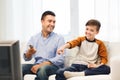 Smiling father and son watching tv at home Royalty Free Stock Photo