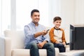 Smiling father and son watching tv at home Royalty Free Stock Photo