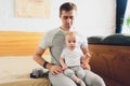 Smiling Father Standing By Window With Baby Son At Home. Royalty Free Stock Photo