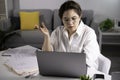 Smiling and feeling positive. happy young Asian woman freelancer working on computer at home. Attractive businesswoman studying on Royalty Free Stock Photo