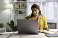 Asian woman freelancer working on computer at home. Attractive businesswoman studying online, using laptop software Royalty Free Stock Photo