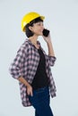 Female architect talking on mobile phone against white background Royalty Free Stock Photo