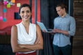 Smiling female business executive standing with arms crossed in office Royalty Free Stock Photo