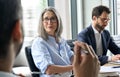 Smiling female ceo looking at male manager colleague at table meeting. Royalty Free Stock Photo